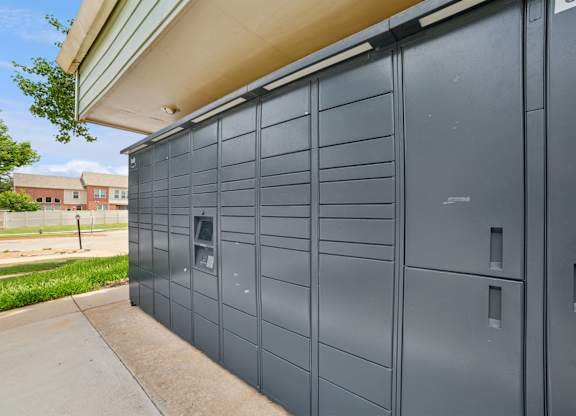 A grey storage unit with a door and a small window.