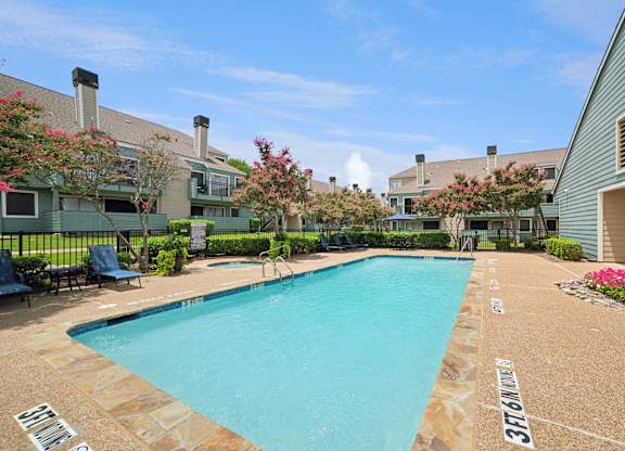 A swimming pool surrounded by a stone border with the number 37161 painted on it.