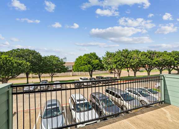 A parking lot with cars and trees.