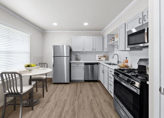 a kitchen with white cabinetry and stainless steel appliances  at Sunset Heights, San Antonio, TX, 78209