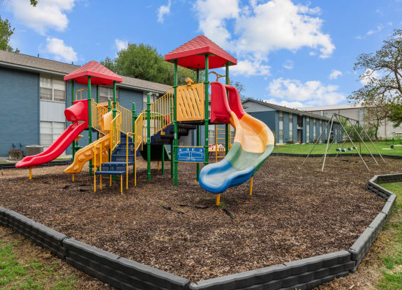 a playground at the whispering winds apartments in pearland, tx  at Sunset Heights, San Antonio, TX