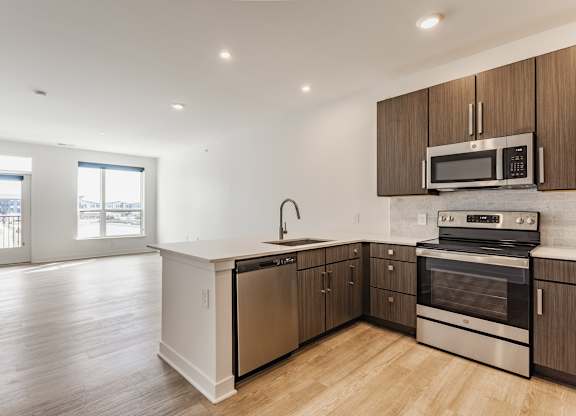 A kitchen with wooden cabinets and stainless steel appliances at Upper Vue Flats, Dublin