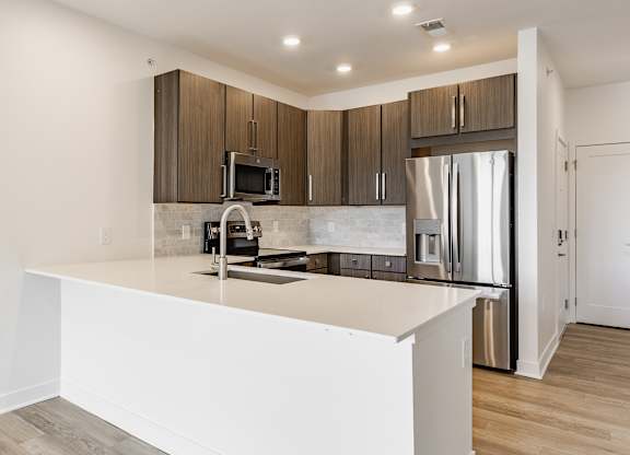 A modern kitchen with a white countertop and stainless steel appliances at Upper Vue Flats, Dublin