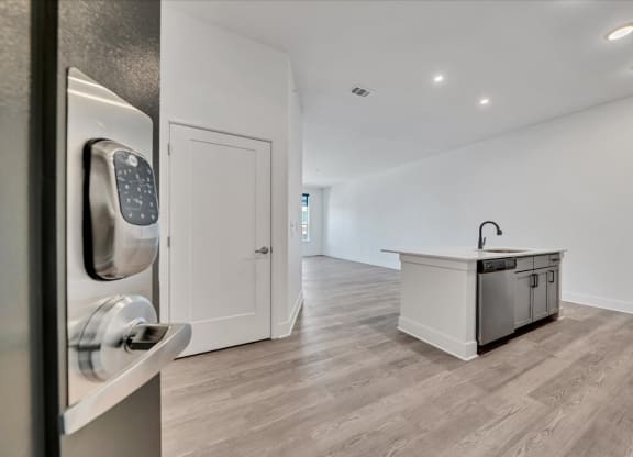a white kitchen with a counter and a door with a door handle at Luxe 360 on Centerpointe Apartments, Midlothian, VA