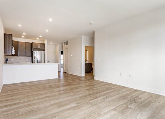 A spacious kitchen with wooden floors and white walls at Upper Vue Flats, Dublin