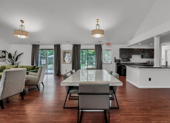a kitchen and lounge room with a table and chairs in a clubhouse  at Polo Run Apartments, Greenwood, IN