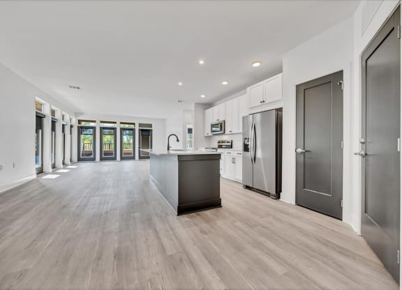the kitchen is open to the living room and dining room at Luxe 360 on Centerpointe Apartments, Virginia, 23114