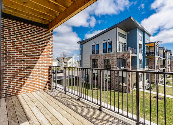 A modern building with a balcony overlooking a grassy area at Upper Vue Flats, Dublin