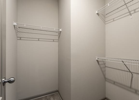 a walk in closet with two white closets and a door at Bella Vista Apartments, Fishers