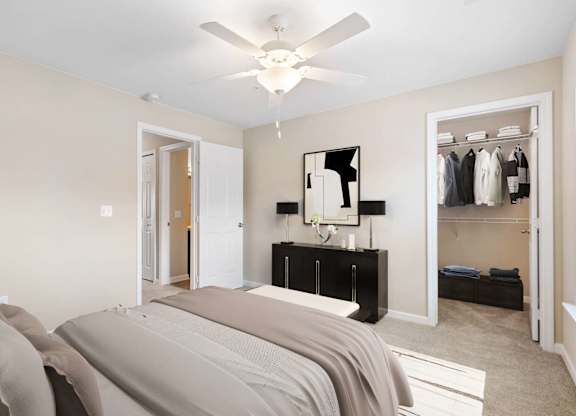 A bedroom with a bed, mirror, and closet.