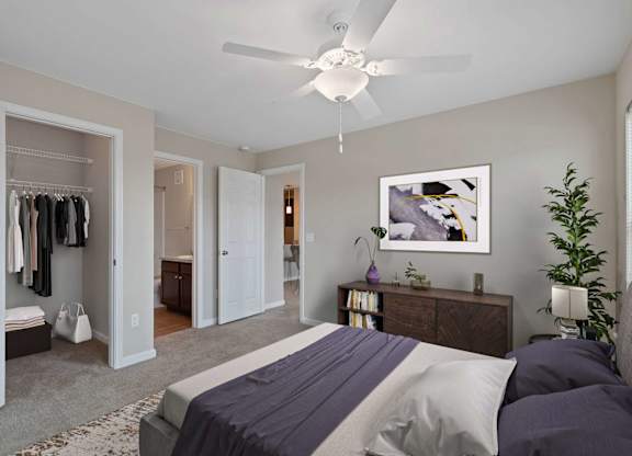 A bedroom with a bed, dresser, and closet.