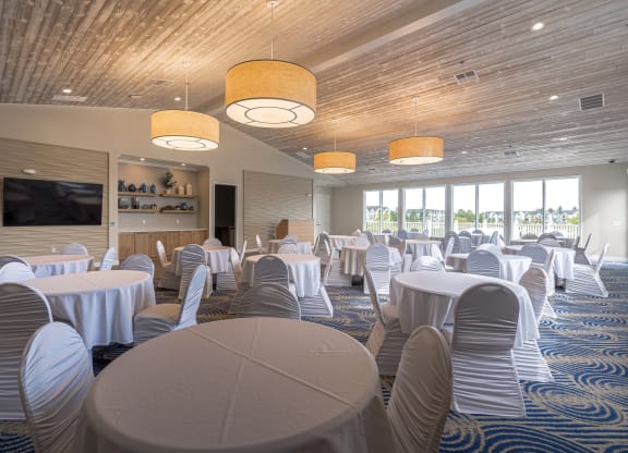 a large room with tables and chairsat The Harbours Apartments, Michigan