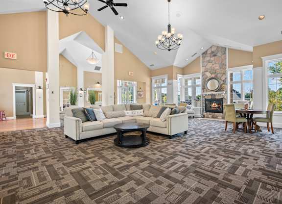 A spacious living room with a patterned carpet and a fireplacek at Timberlane Apartments, Peoria, Illinois