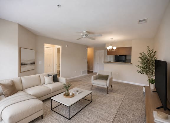 A living room with a white couch and a coffee table.