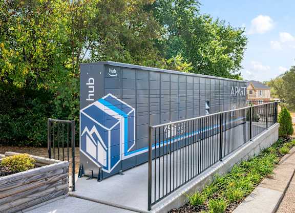 A modern building with a blue and white logo on itk at Timberlane Apartments, Peoria, Illinois