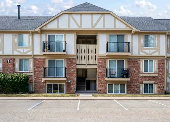 A large brick building with a white trim and a black roofk at Timberlane Apartments, Peoria, Illinois