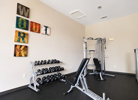 A gym with weights and exercise equipment.
