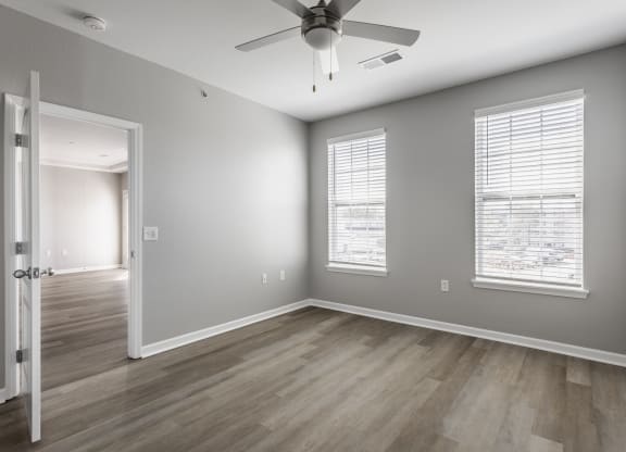 the living room of an empty house with a ceiling fan at Alexandria of Carmel Apartments, Carmel, 46032