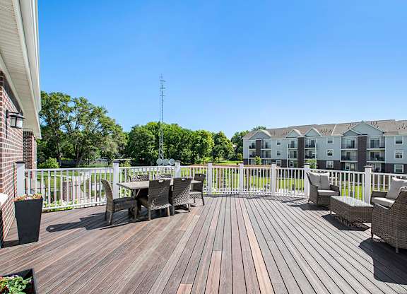 A deck with chairs and tables at Andover Pointe Apartment Homes, La Vista, NE, 68138