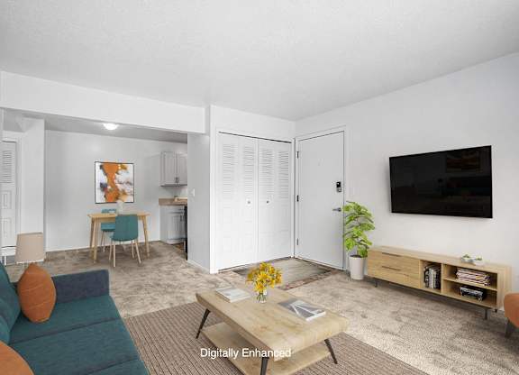 A living and dining room with plush carpeting  at Apple Ridge Apartments, Walker, MI