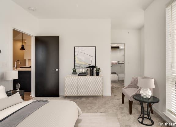 a bedroom with a bed sitting next to a window  at Uptown Square Apartments, Troy, MI