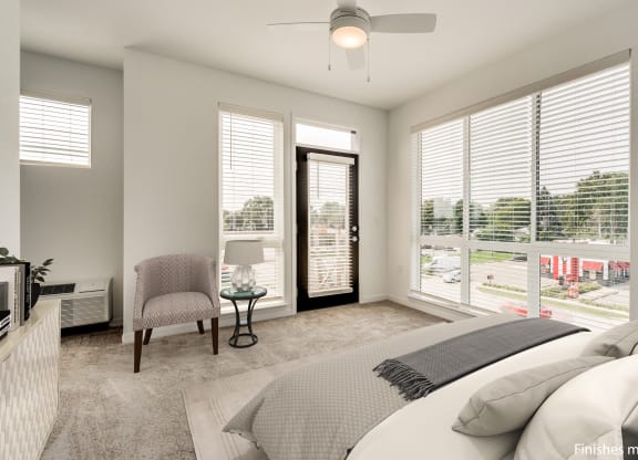 a bedroom with a bed and a chair  at Uptown Square Apartments, Michigan