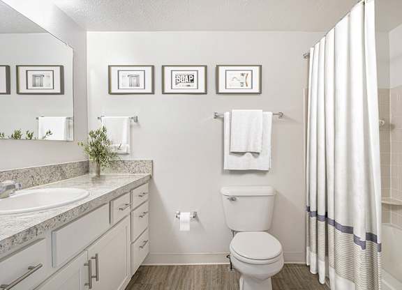 A bathroom with a toilet, sink, and shower at Autumn Lakes Apartments and Townhomes, Mishawaka, 46544