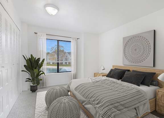 A bedroom with a large bed and a large window at Autumn Lakes Apartments and Townhomes, Mishawaka, 46544