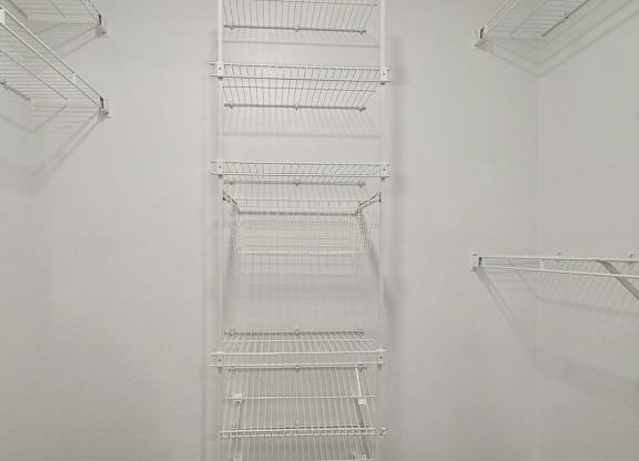 A walk-in closet with wardrobe organizers at Autumn Lakes Apartments and Townhomes, Mishawaka, 46544
