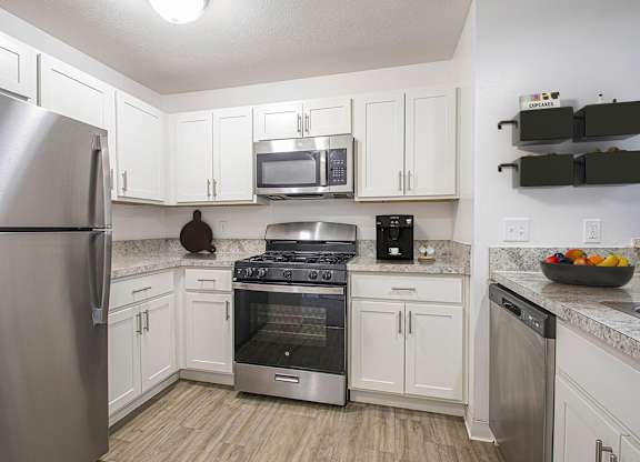 A kitchen with white cabinets and a stainless steel appliances at Autumn Lakes Apartments and Townhomes, Mishawaka, 46544