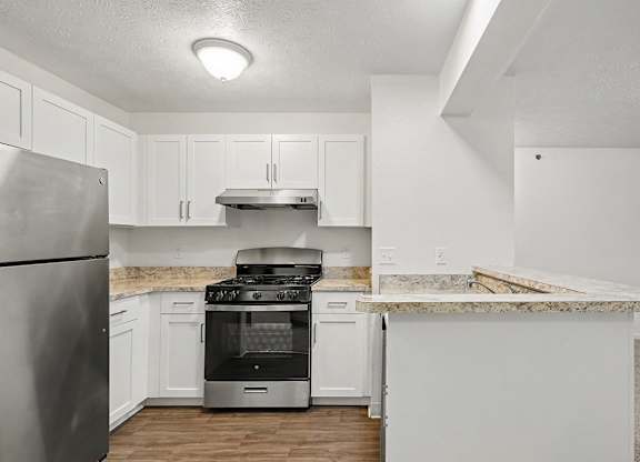 A kitchen with white cabinets and a stainless steel refrigerator at Autumn Lakes Apartments and Townhomes, Mishawaka, 46544