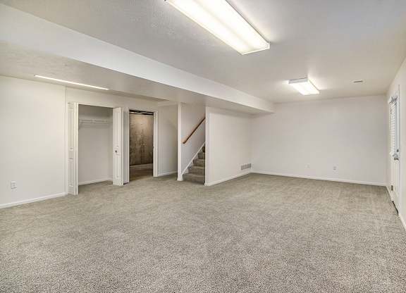 A spacious room with a staircase and a window at Autumn Lakes Apartments and Townhomes, Mishawaka, 46544