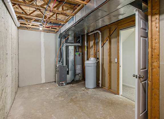 A room under construction with a wood beam ceiling and a doorway leading to another room at Autumn Lakes Apartments and Townhomes, Mishawaka, 46544