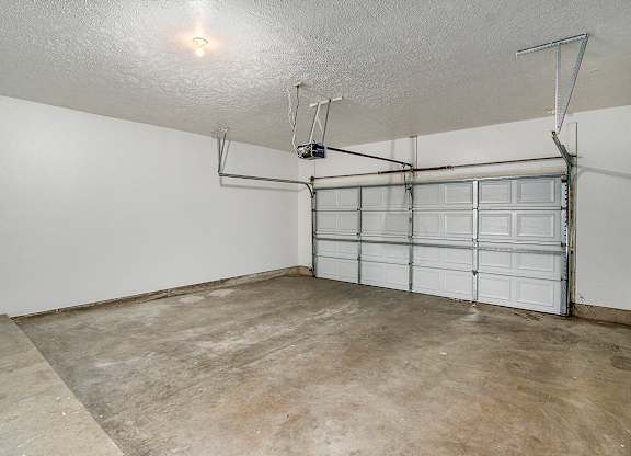 A garage with a white wall and a white door at Autumn Lakes Apartments and Townhomes, Mishawaka, 46544