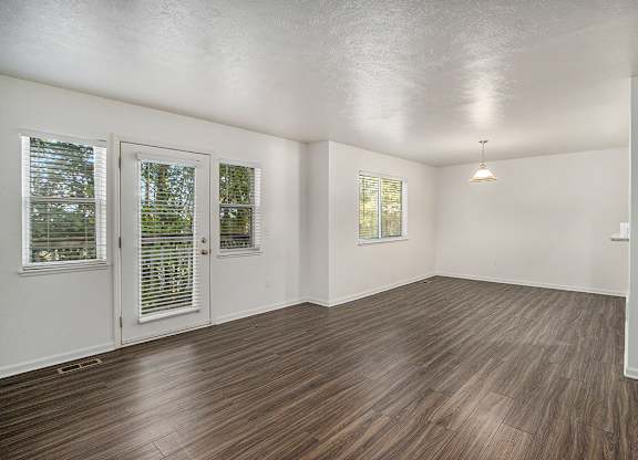 A living and dining room with vinyl plank flooring and white walls at Autumn Lakes Apartments and Townhomes, Mishawaka, 46544