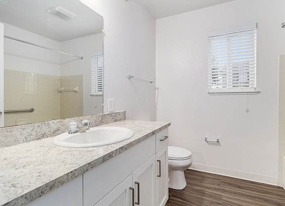 A white bathroom with a sink, toilet, and bathtub at Autumn Lakes Apartments and Townhomes, Mishawaka, 46544