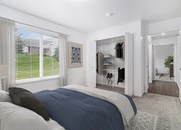 A bedroom with a large bed and a walk-in closet at Autumn Lakes Apartments and Townhomes, Mishawaka, 46544