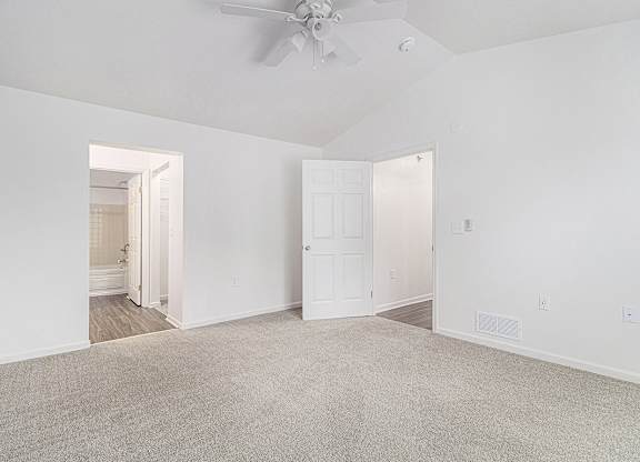 A bedroom with a high ceiling, ceiling fan and carpeted floor at Autumn Lakes Apartments and Townhomes, Mishawaka, 46544