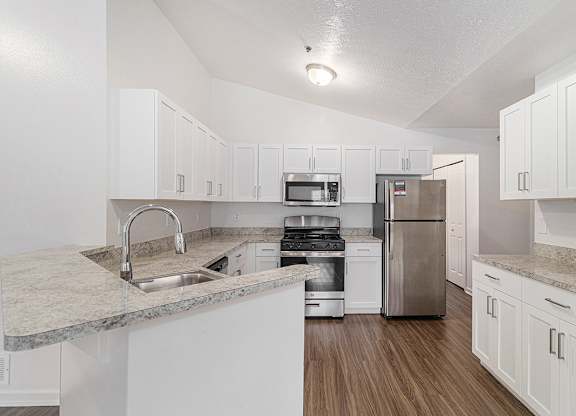 A kitchen with white shaker-style  cabinets and stainless steel appliances at Autumn Lakes Apartments and Townhomes, Mishawaka, 46544