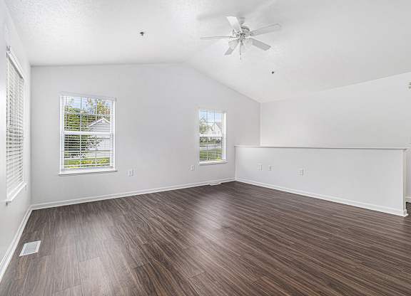 A living room with vinyl plank flooring and a ceiling fan at Autumn Lakes Apartments and Townhomes, Mishawaka, 46544