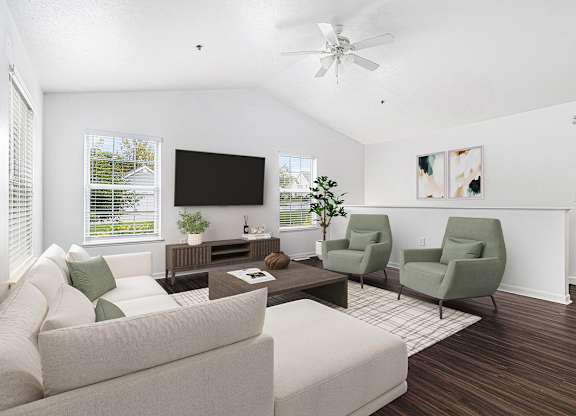 A living room with a couch, a coffee table, and a vaulted ceiling with ceiling fan at Autumn Lakes Apartments and Townhomes, Mishawaka, 46544