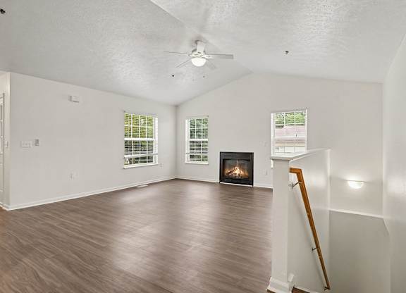 A living room with a fireplace and a hard-surface floor at Autumn Lakes Apartments and Townhomes, Mishawaka, 46544