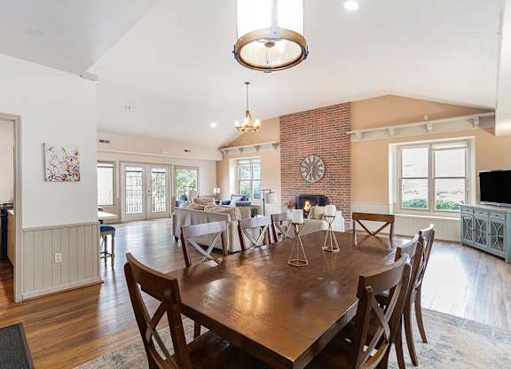 A clubhouse dining room with a wooden table and chairs at Autumn Lakes Apartments and Townhomes, Mishawaka, IN