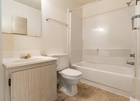 A white toilet sits next to a sink in a bathroom