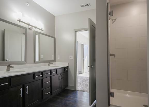 an empty bathroom with two sinks and a shower at Avant & Avant II, Carmel, IN, 46032