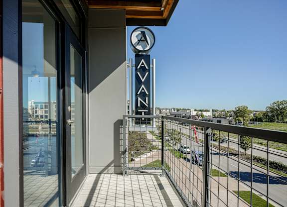 a balcony with a view of a building with a sign on the side of it at Avant & Avant II, Carmel, IN, 46032