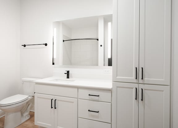 a bathroom with white cabinets and a toilet and a sink at Avant & Avant II, Carmel, IN, 46032