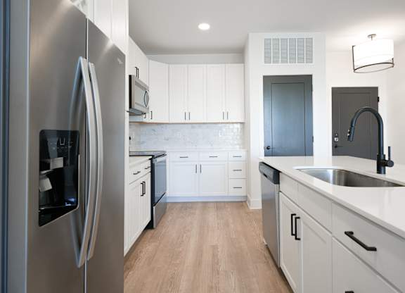 a kitchen with white cabinets and stainless steel appliances at Avant & Avant II, Carmel, IN, 46032