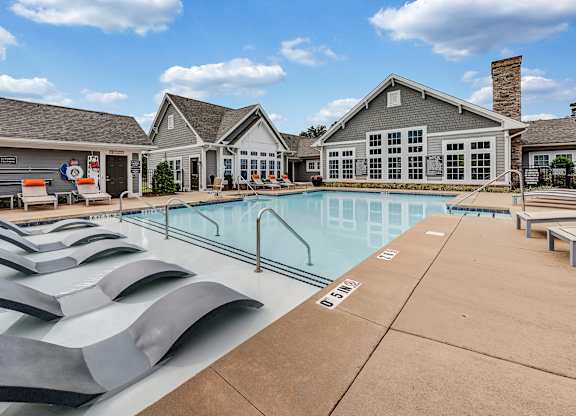 pool and building with lounge chairs at Avellan Springs Apartments, Morrisville, NC