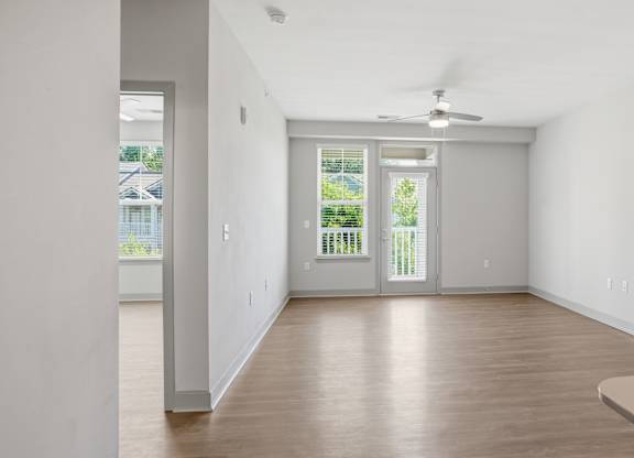 A room with a sliding glass door leading to a balcony.
